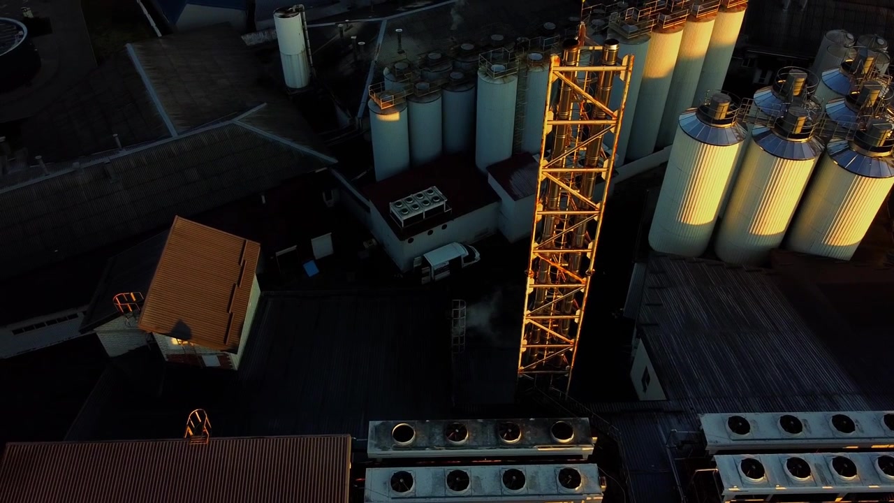Aerial view of a drone flying over the beer production plant, several rows of tanks.