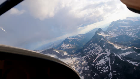 Aircraft-flying-over-snowcovered-mountain-4k