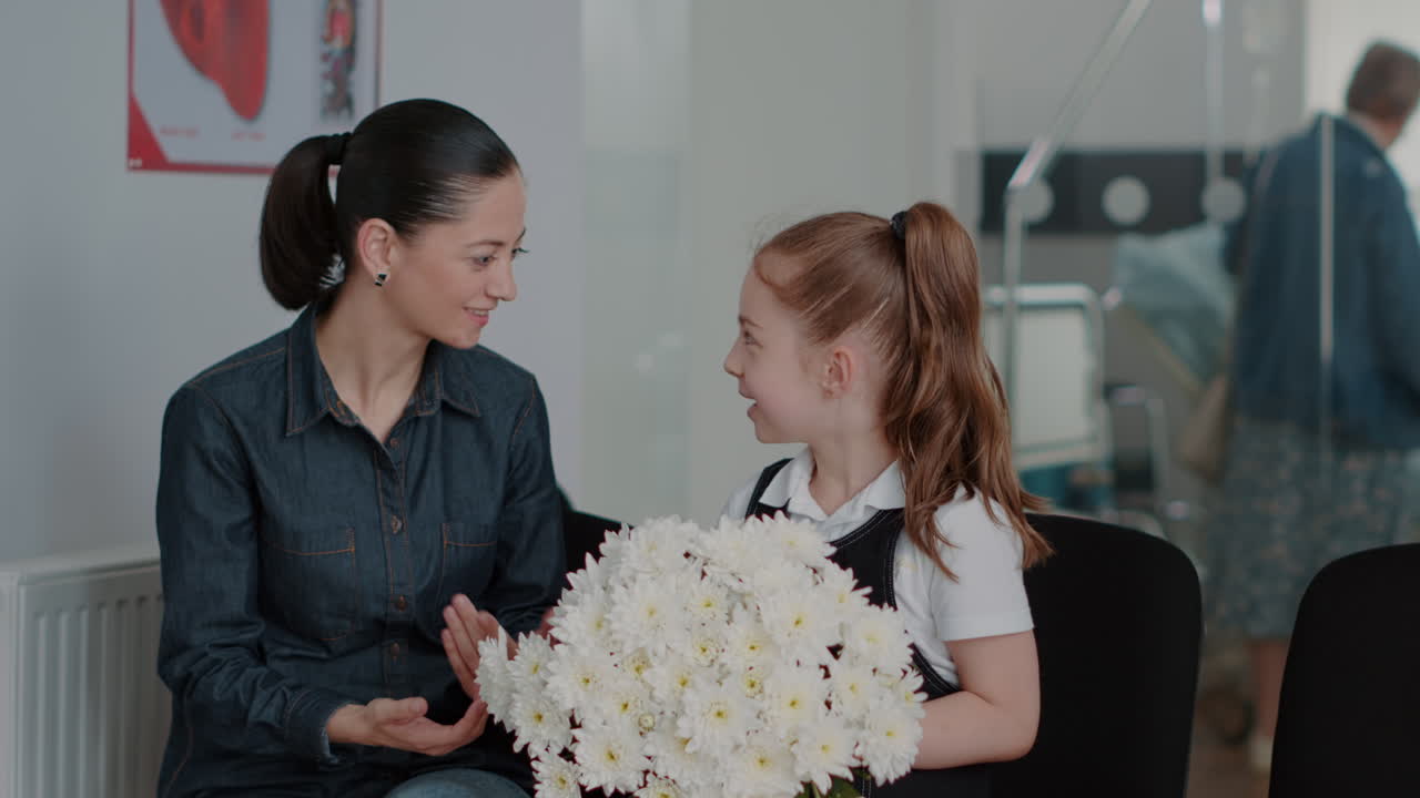 Close up of mother and child in waiting area preparing to visit patient