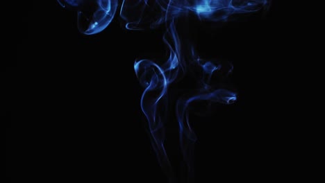 abstract blue color smoke with a black background in slow motion