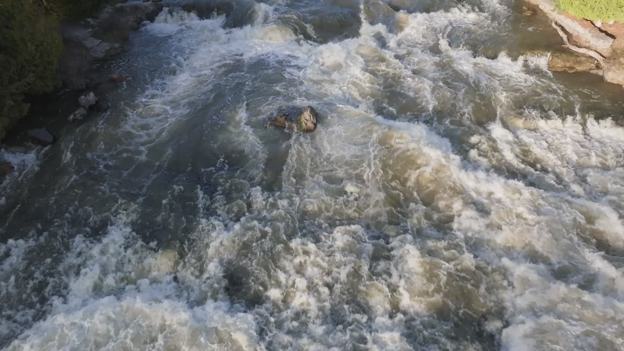 Rushing waterfall in Owen Sound, Canada with turbulent waters and rocky surroundings