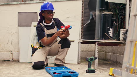 mechanic prepares for condenser checkup