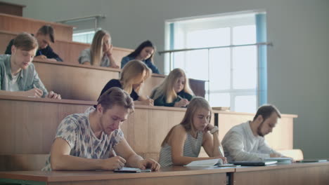 Hands-of-the-Lecturer-while-he-Gives-Lecture-to-a-Classroom-Full-Of-Students.-Young-People-Listening-to-a-Lecture-in-the-University.