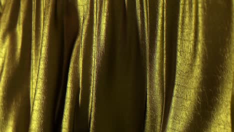 folds of golden fabric sway in the wind. texture. close-up. 3d animation