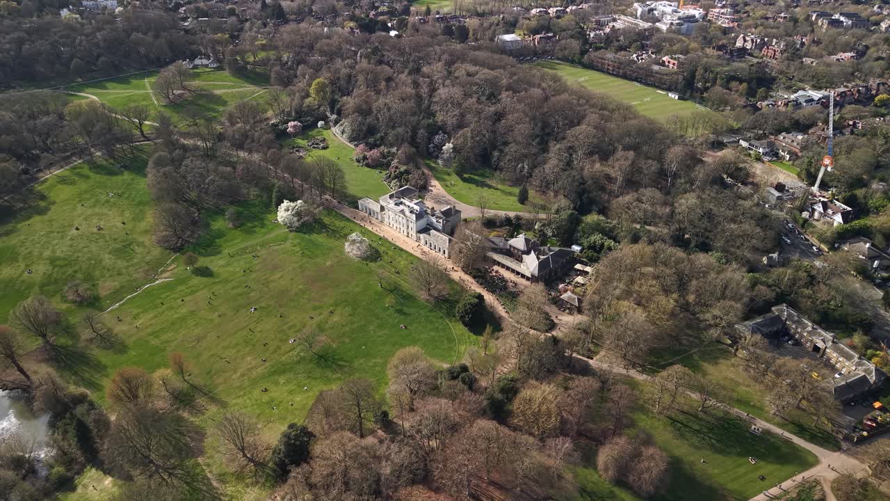 Aerial view flying high above Kenwood house grand estate and surrounding woodland gardens in London