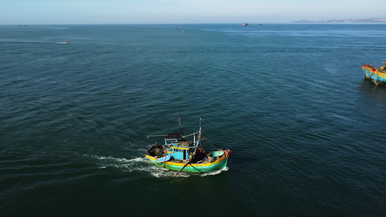 toma aérea de seguimiento del barco de pescadores que regresa a casa después del día de pesca