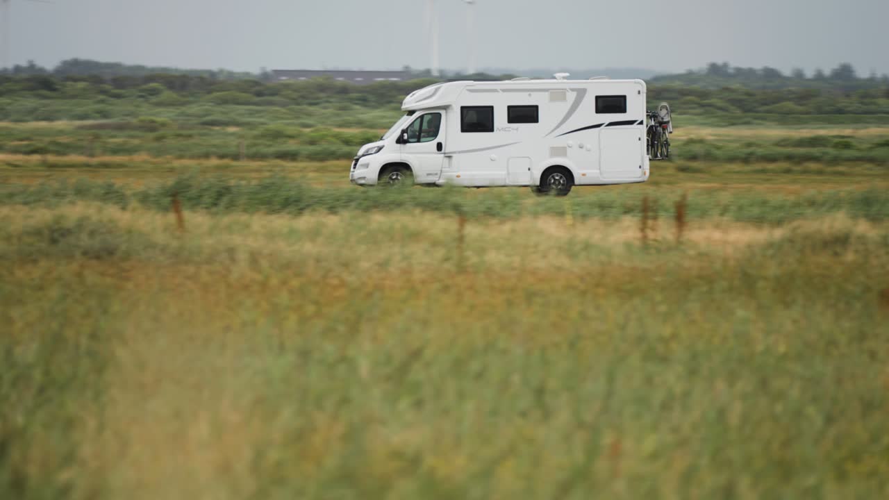 A motorhome driving through the fields