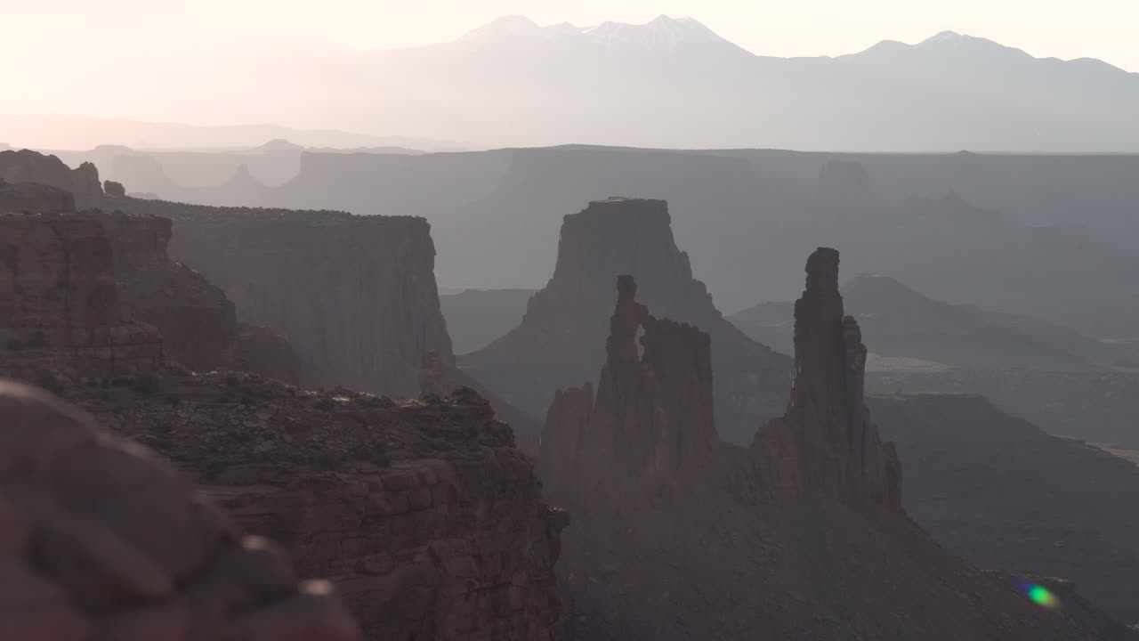 Canyonlands national park in Utah washer woman rock formation seen from Mesa arch at sunset, Aerial pedestal rising shot
