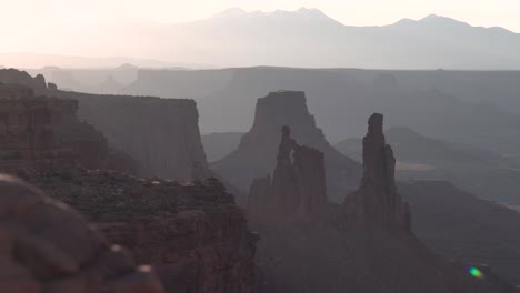 canyonlands national park in utah washer woman rock formation seen from mesa arch at sunset, aerial pedestal rising shot