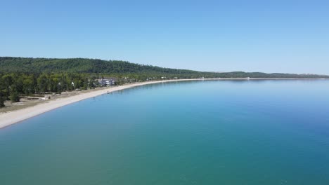 Lake-Michigan-shoreline-with-small-town-of-Glen-Arbor,-aerial-drone-view