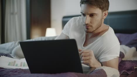 Casual-man-working-online-on-laptop-computer-at-home.-Serious-man-work-notebook