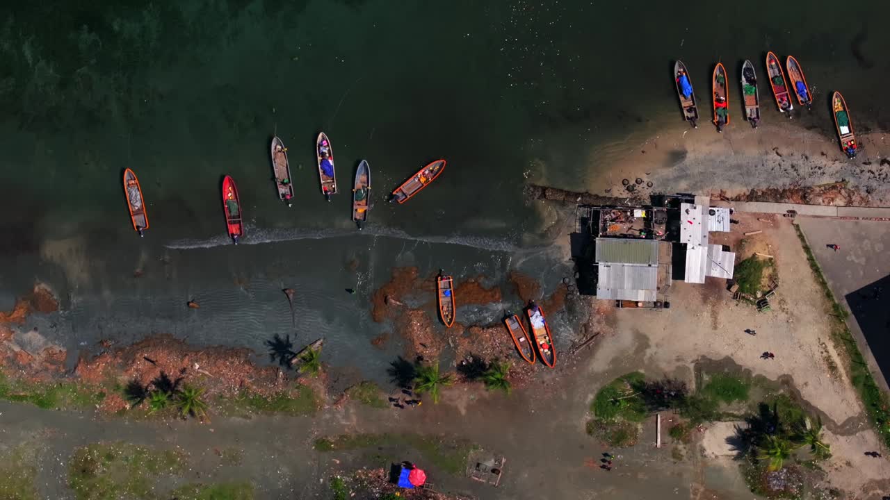 Wewak District coastal town Suduan fish Market aerial drone birdseye view Papua New Guinea colorful dugout lakatoi boats outrigger fishing canoes people walking Madang Meri Beach Dogreto Bay coastline