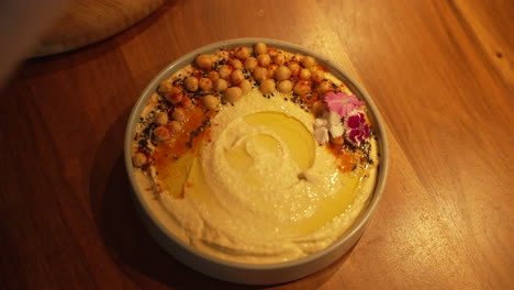 Professional-Chief-preparing-a-Hummus-dish-for-their-guests