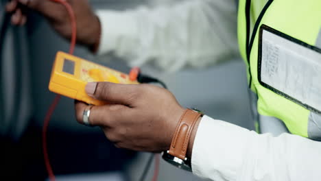 Technician,-hands-and-multimeter-testing-power