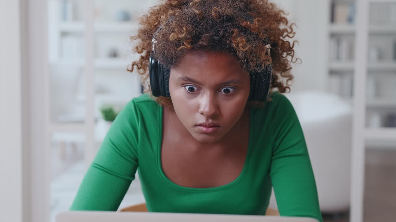 Young shocked african american woman sees error in laptop sits in home office