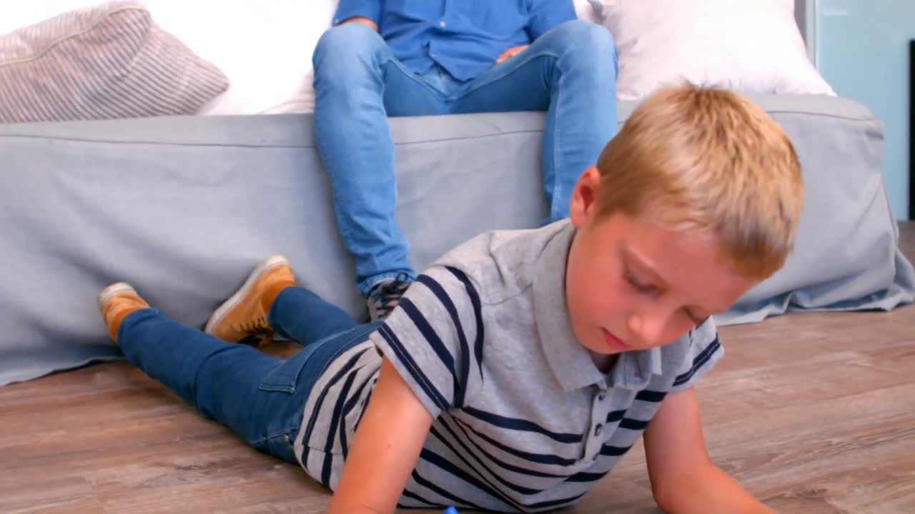 Son drawing while father watching him