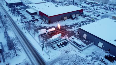 A-revealing-shot-of-an-early-winter-morning-with-huge-gas-flames-in-an-industrial-zone