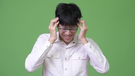 young asian businessman having headache