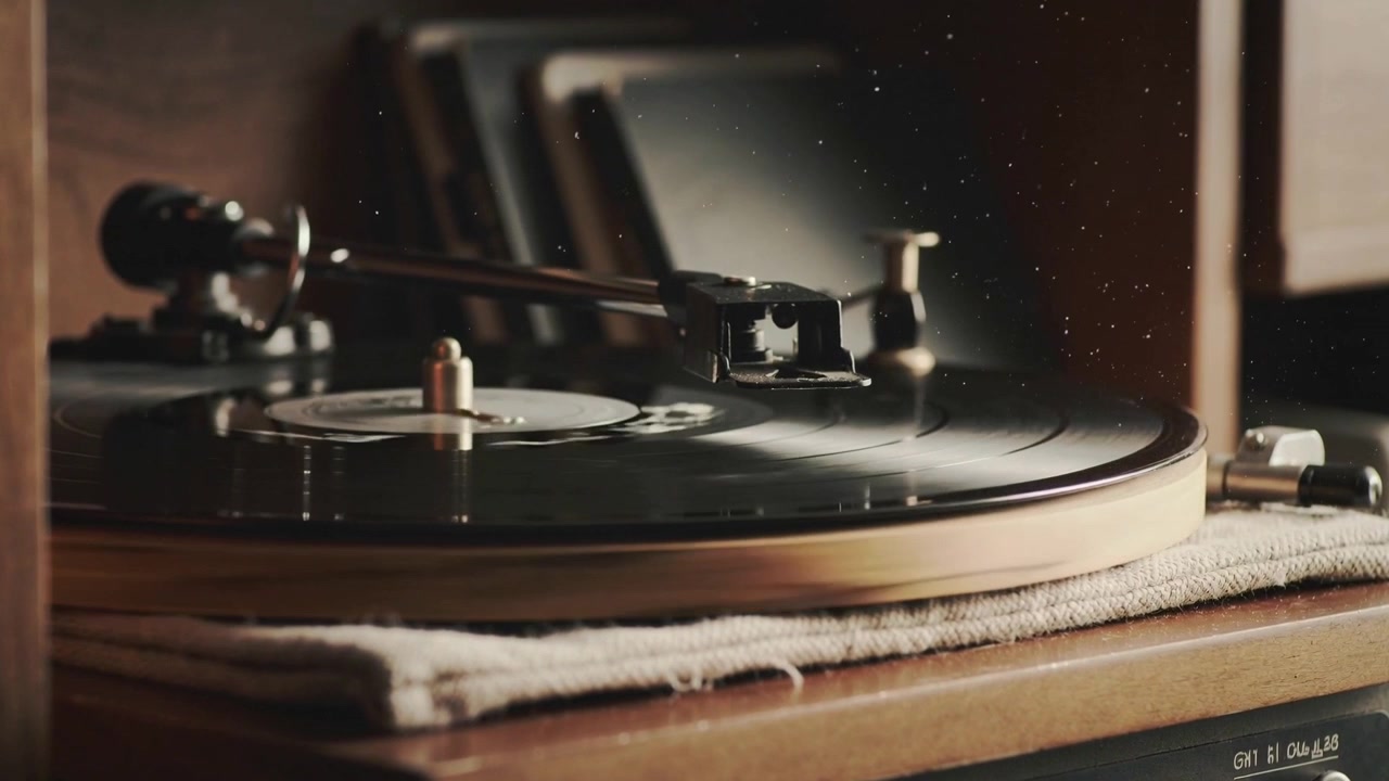 Lowering tonearm, turntable spinning record on wooden cabinet, stylus tracking groove for playback