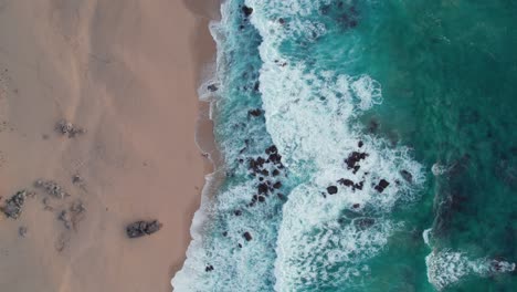 waves crashing on rocky beach in portugal