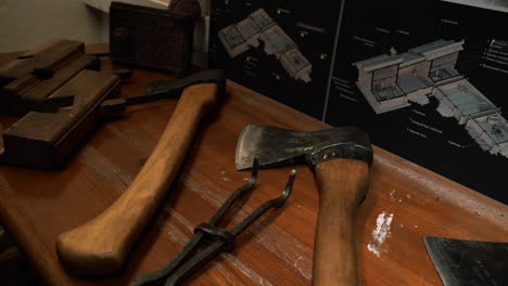 old axes and tools on a wooden table