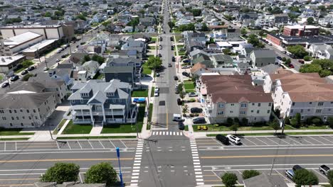 luxury beach houses with swimming pool in garden in wildwood, new jersey. main street and junction of small town. aerial birds eye shot. sunny summer day in america