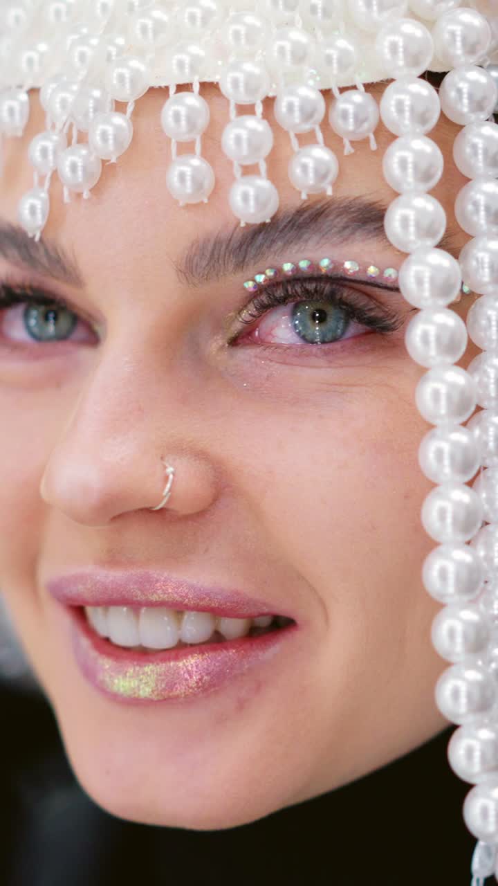 Close-up of a Woman with Pearl Headpiece and Glitter Makeup