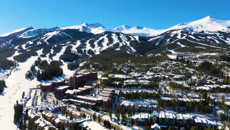 breckenridge, colorado rocky mountainside aerial drone video of ski slopes, chairlift and vacation rental homes