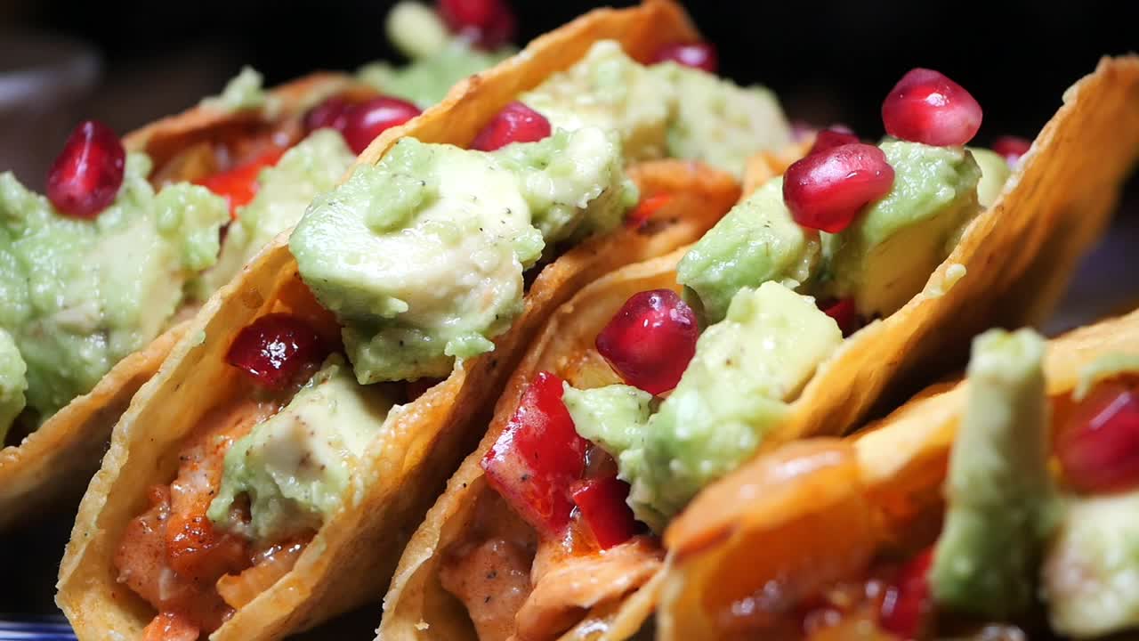 Close-up of Chicken Tacos with Avocado, Guacamole, and Pomegranate
