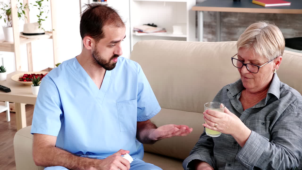 Elderly retired woman in nursing home with male doctor