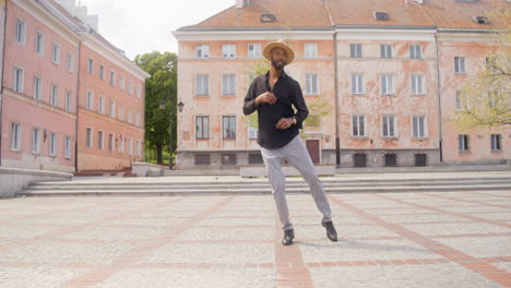 afro caribbean man dancing alone in a public square 1