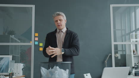 man throwing away papers in the office