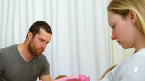 father putting his baby to sleep on baby bed 4k