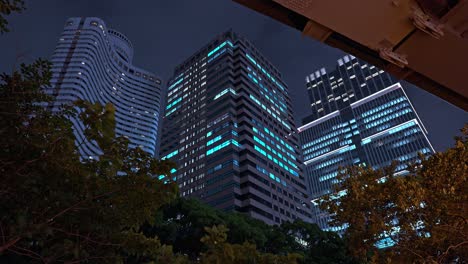 a view of a modern skyscraper in akasaka-mitsuke, tokyo, showcasing its glass and steel facade and prominence in the urban landscape, framed by a cloudy sky.