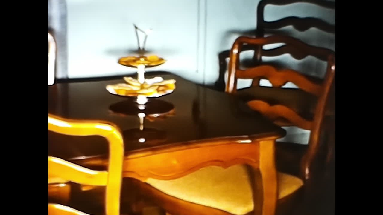 Young Boy Riding Toy Bike in Living Room. CIRCA USA - 1970s: A young boy energetically rides a toy bike in a 1970s living room setting in the USA.