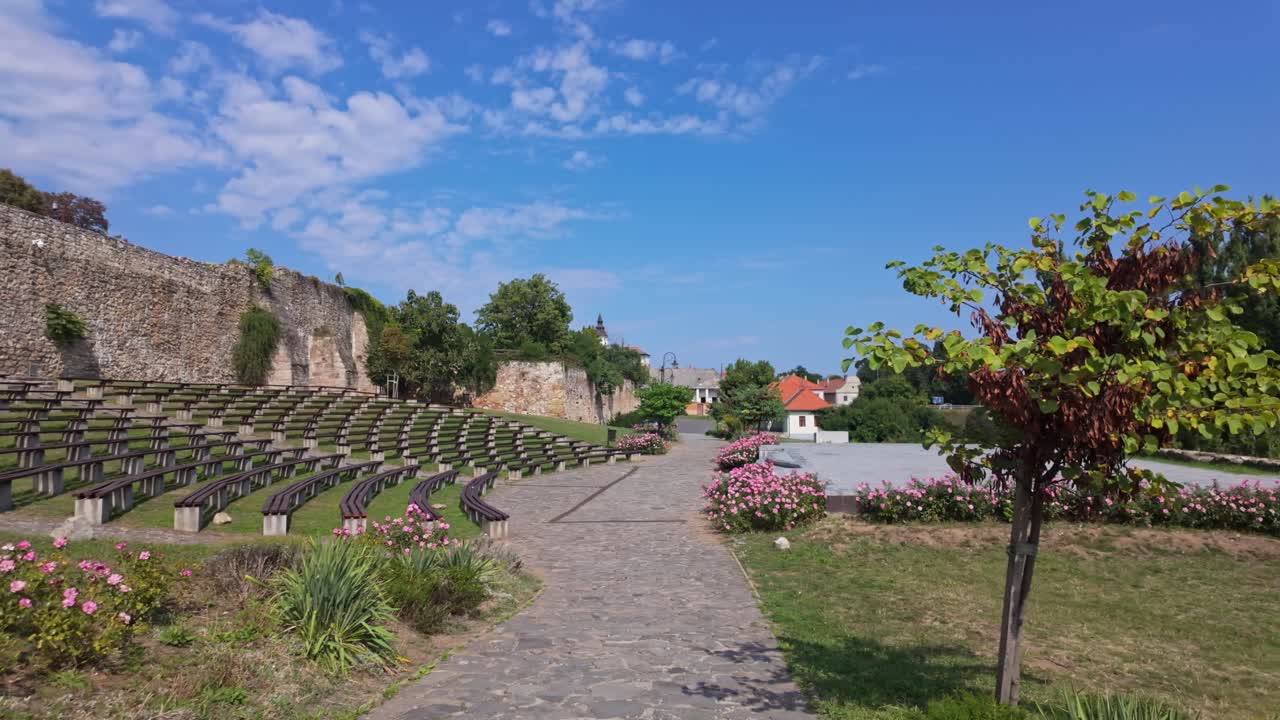 The iconic Vízikapu Open Air Stage in a flowery medieval setting on a sunny day in Sárospatak, Hungary