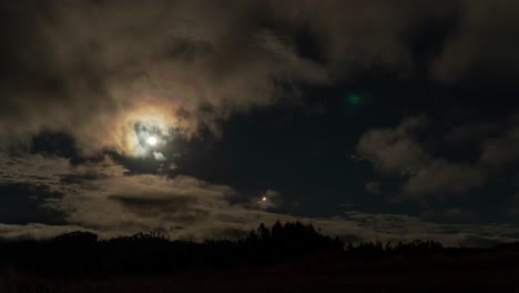 bright full moon in night sky with clouds passing by, timelapse