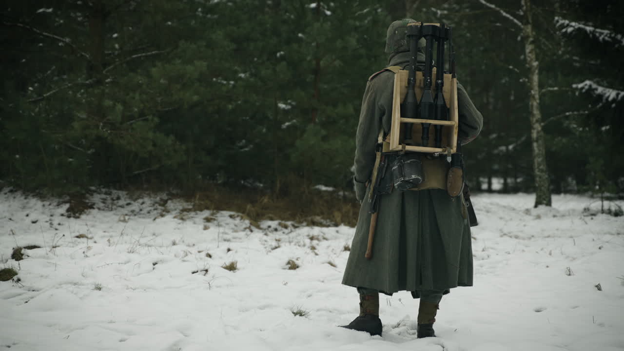 German soldier in winter uniform with weapons in the snow