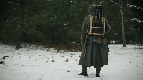german soldier in winter uniform with weapons in the snow