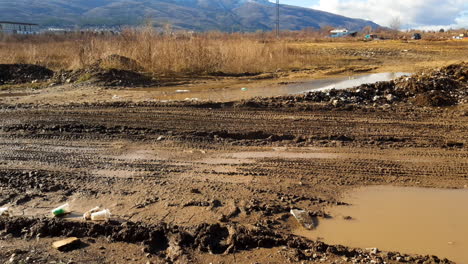 Muddy-off-road-and-a-crane-with-a-beautiful-mountain-in-the-background