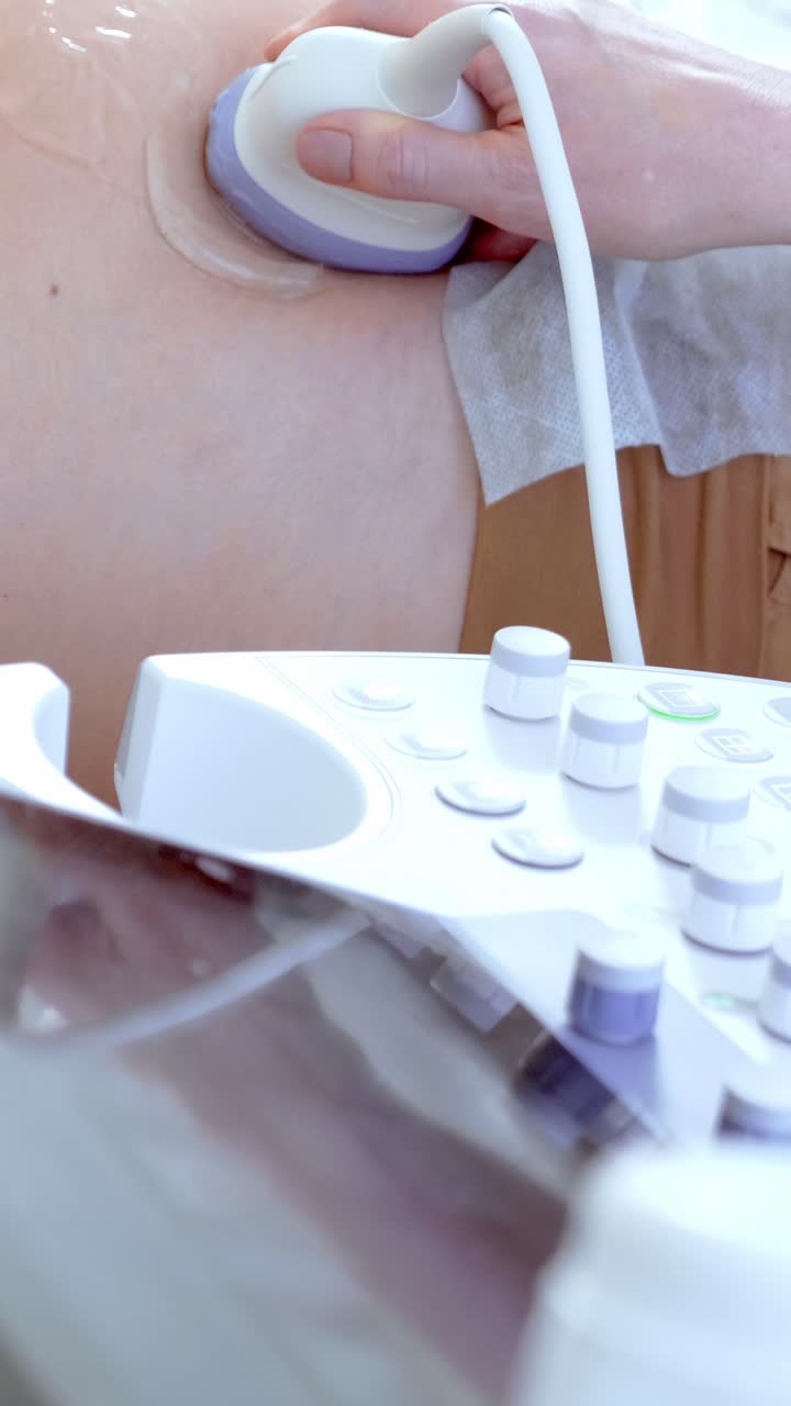 Medical professional using ultrasound device on patients skin for diagnostic imaging procedure