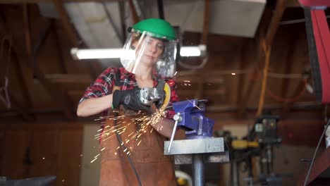 slow motion still shot, woman grinding steel in workshop, sparks flying