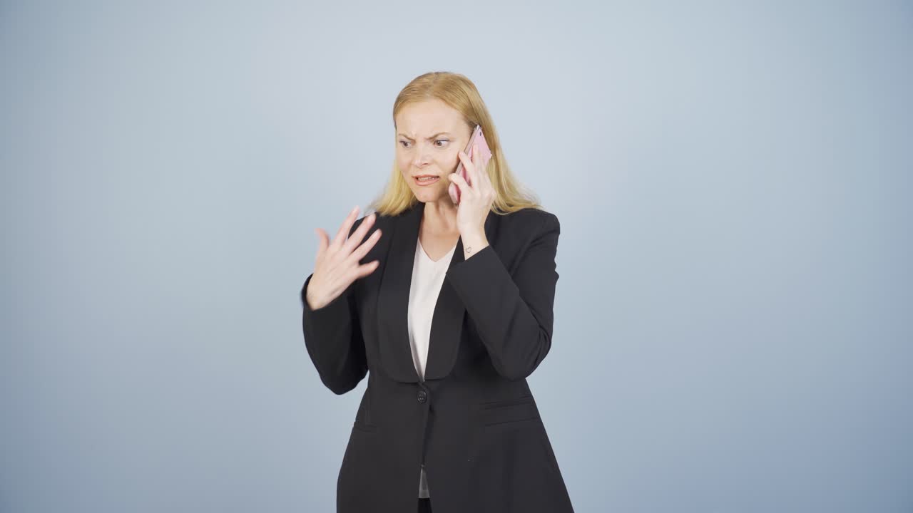 Angry talking business woman on the phone.