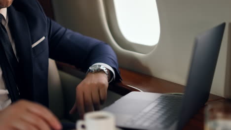 Man-starting-online-call-on-business-jet.-Closeup-businessman-hand-waving-laptop