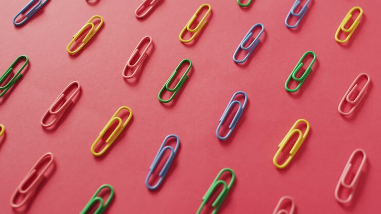 Video of composition with colorful pins on red surface