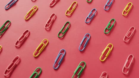 video of composition with colorful pins on red surface