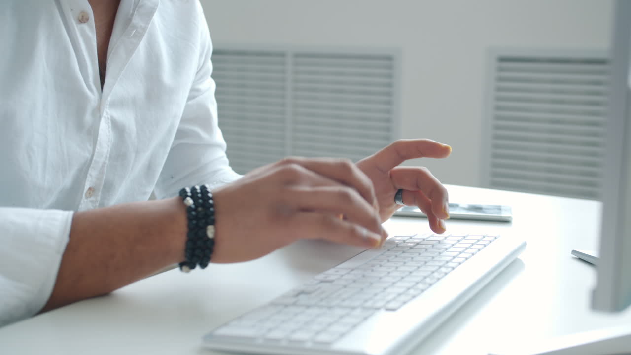 Person Typing on a Keyboard in an Office