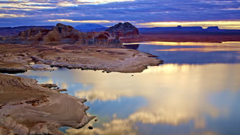 A dynamic aerial shot displaying the endless desert beauty and dramatic red rocks near Lake Powell.