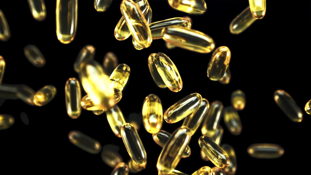 Capsule dorate di olio di pesce Omega-3 che cadono al rallentatore