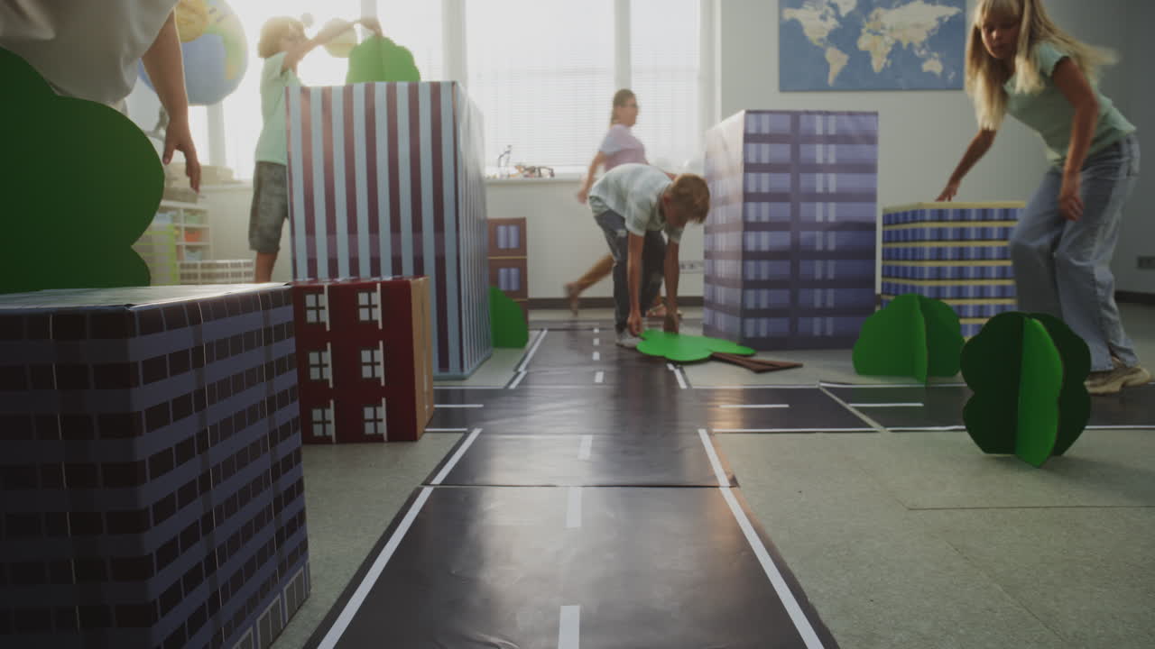 Team of Primary School Students Moving Blocks Creating City Planning